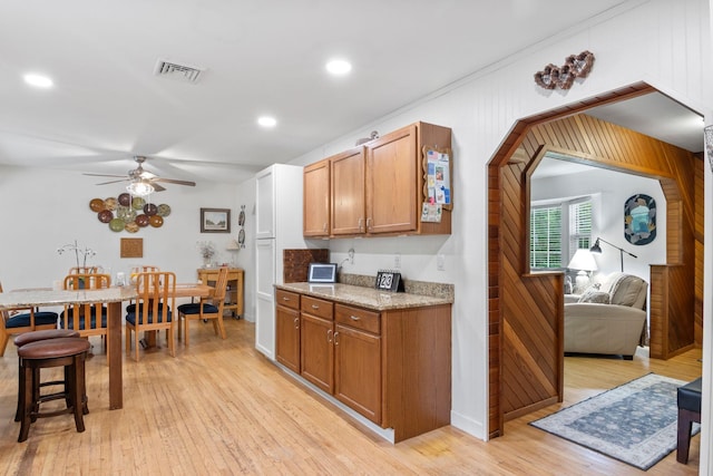 60 Heston Rd, Shirley, NY 11967 - kitchen with ceiling fan, light wood finished floors, brown cabinets, recessed lighting, and light stone counters