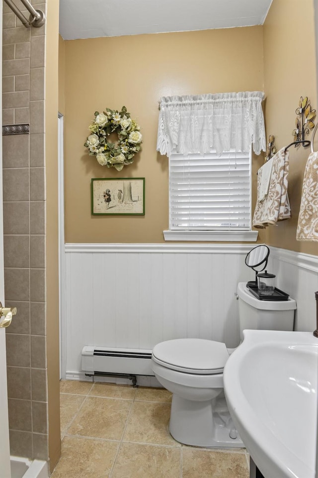 60 Heston Rd, Shirley, NY 11967 - full bathroom with baseboard heating, tiled shower, wainscoting, toilet, and a sink