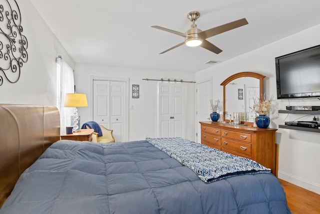60 Heston Rd, Shirley, NY 11967 - bedroom with wood finished floors, two closets, ceiling fan, and baseboards