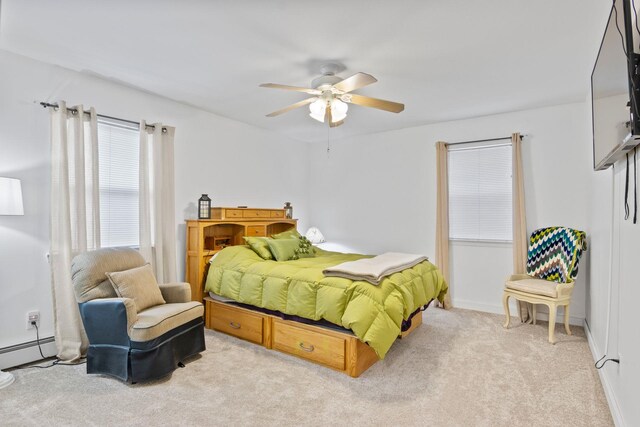 60 Heston Rd, Shirley, NY 11967 - bedroom with light colored carpet, a baseboard heating unit, and a ceiling fan