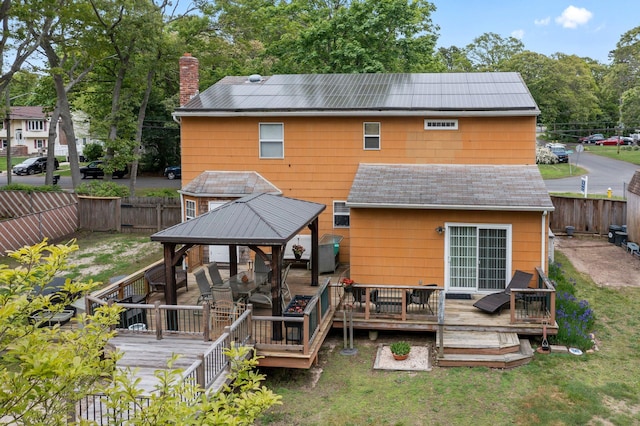 60 Heston Rd, Shirley, NY 11967 - rear view of house with a gazebo, roof with shingles, a chimney, and a wooden deck