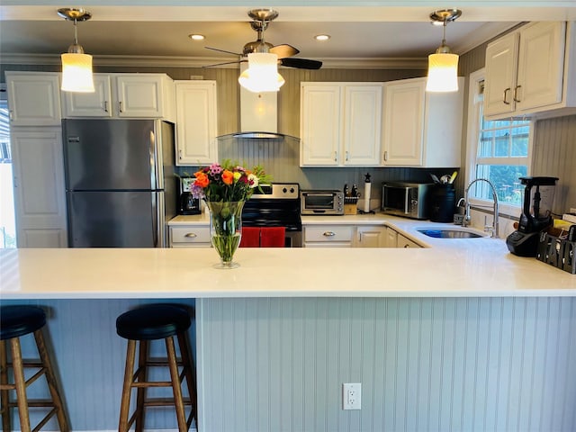 24 Lowerre St, Babylon, NY 11702 - kitchen with appliances with stainless steel finishes, a sink, white cabinets, a peninsula, and decorative light fixtures
