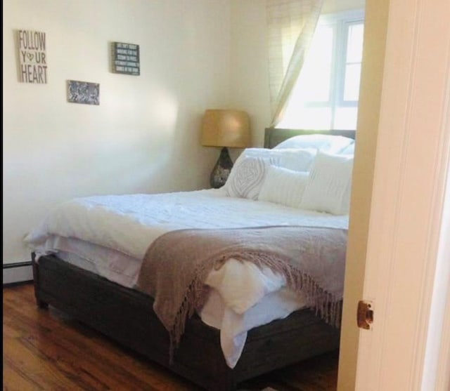 24 Lowerre St, Babylon, NY 11702 - bedroom featuring wood finished floors and a baseboard radiator