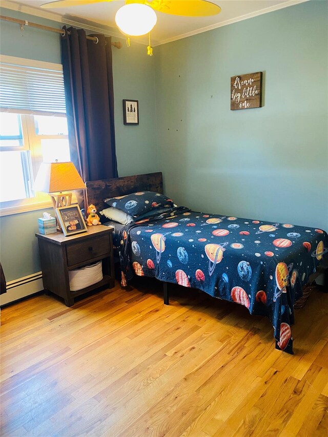 24 Lowerre St, Babylon, NY 11702 - bedroom with crown molding, wood finished floors, and a baseboard heating unit