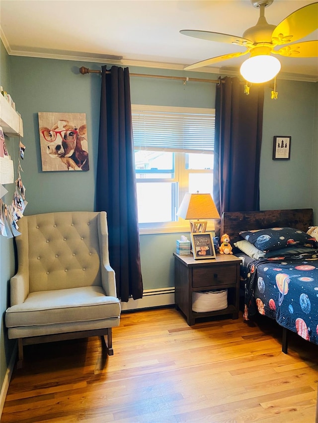 24 Lowerre St, Babylon, NY 11702 - bedroom with crown molding, wood finished floors, a ceiling fan, and a baseboard radiator
