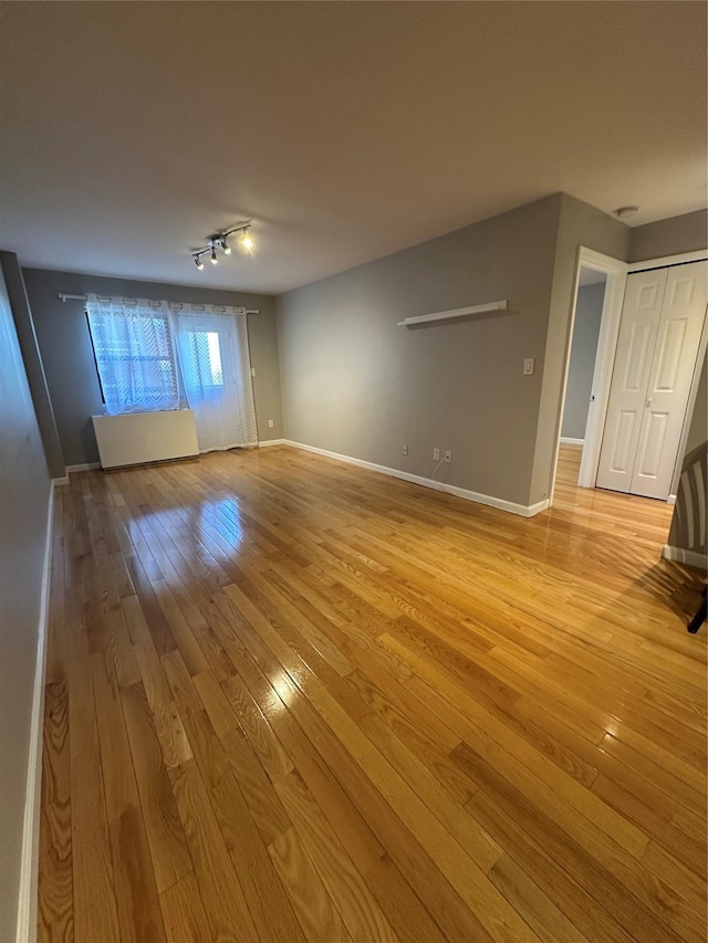 87-30 62nd Ave Unit 5-E, Rego Park, NY 11374 - spare room featuring light wood finished floors and baseboards