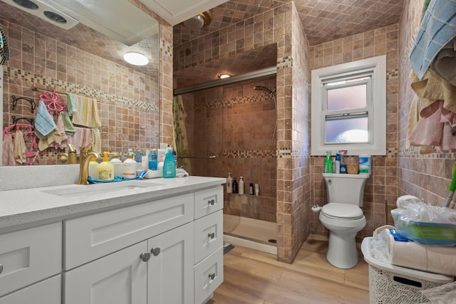 669 W Fingerboard Rd, Staten Island, NY 10305 - bathroom with tile walls, vanity, a stall shower, wood finished floors, and toilet