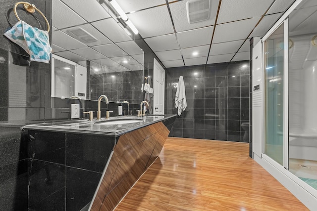 669 W Fingerboard Rd, Staten Island, NY 10305 - full bath with double vanity, wood finished floors, a stall shower, tile walls, and recessed lighting