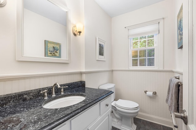 10 Catherine Pl, Katonah, NY 10536 - bathroom with a wainscoted wall, toilet, vanity, and tile patterned floors