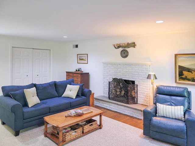 10 Catherine Pl, Katonah, NY 10536 - living area featuring a brick fireplace, wood finished floors, recessed lighting, and crown molding
