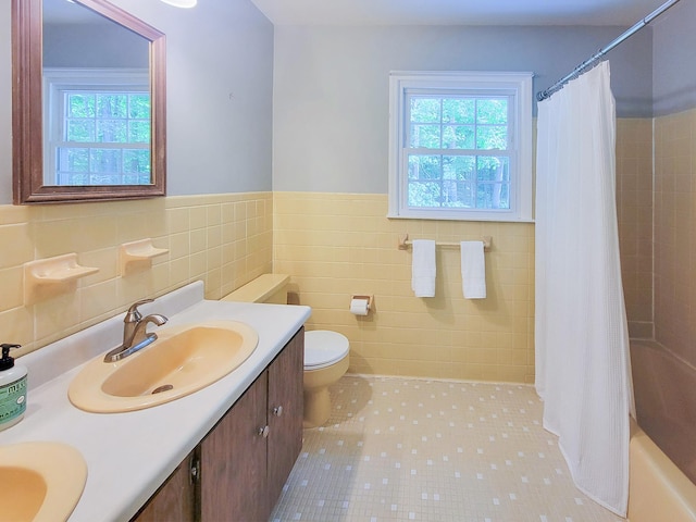 10 Catherine Pl, Katonah, NY 10536 - bathroom featuring tile walls, plenty of natural light, vanity, toilet, and a wainscoted wall