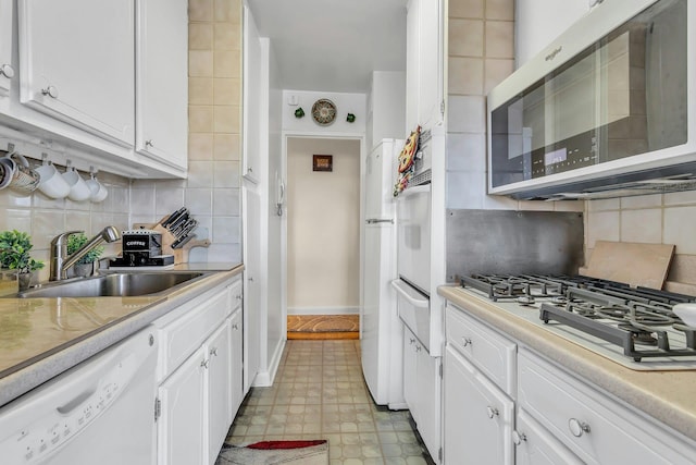 6636 Yellowstone Blvd # 6E, Forest Hills, NY 11375 - kitchen with white appliances, a sink, a warming drawer, white cabinets, and decorative backsplash