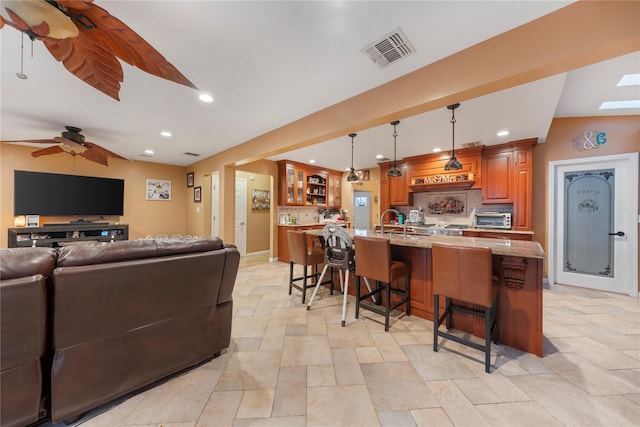 20 Skipper Dr, West Islip, NY 11795 - living area featuring light stone finish flooring, recessed lighting, ceiling fan, and baseboards