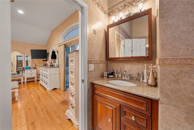20 Skipper Dr, West Islip, NY 11795 - bathroom with wood finished floors, lofted ceiling, vanity, and tile walls