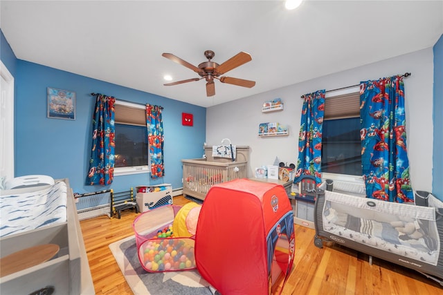 20 Skipper Dr, West Islip, NY 11795 - bedroom with recessed lighting, wood finished floors, a baseboard heating unit, and a ceiling fan