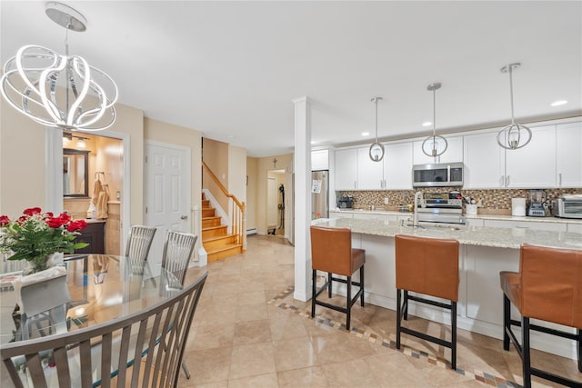 20 Skipper Dr, West Islip, NY 11795 - kitchen featuring appliances with stainless steel finishes, a chandelier, tasteful backsplash, a kitchen breakfast bar, and recessed lighting