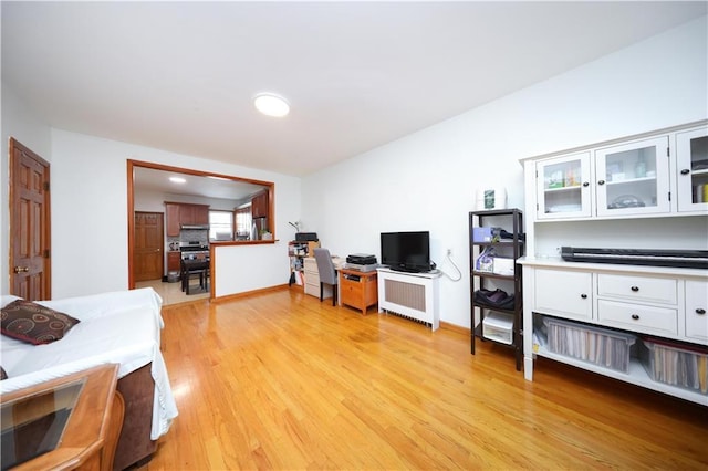living area featuring light wood-type flooring and baseboards
