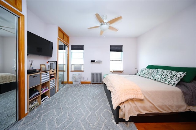 bedroom featuring radiator, ceiling fan, and baseboards