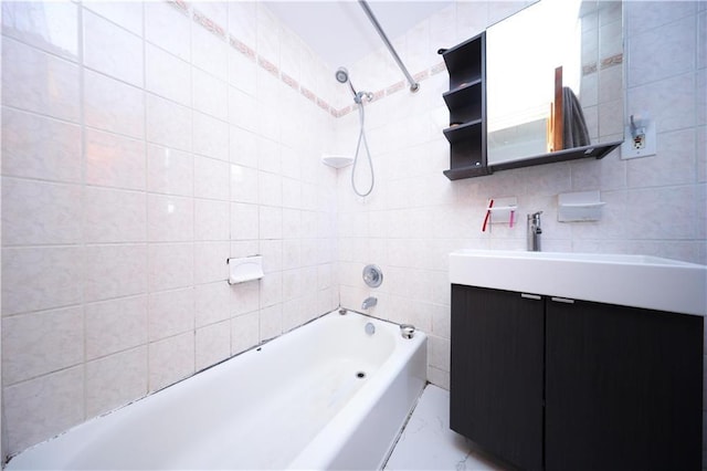 bathroom featuring tile walls, bathing tub / shower combination, and vanity