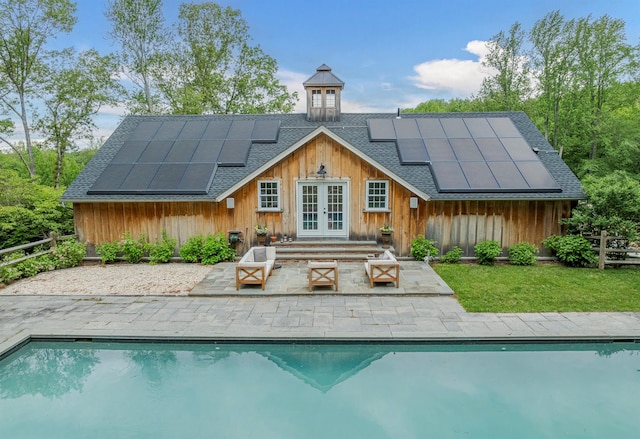 8 Lost Pond Ln, North Salem, NY 10560 - back of property featuring french doors, a shingled roof, solar panels, and an outdoor pool