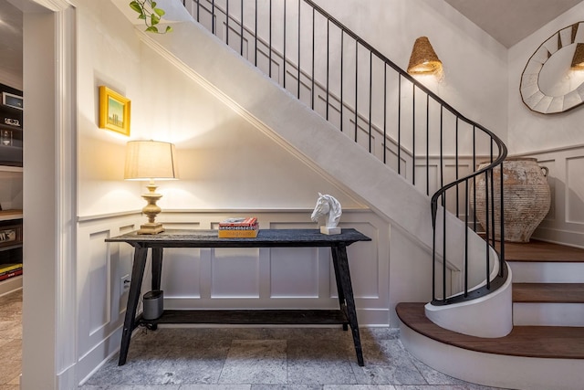 8 Lost Pond Ln, North Salem, NY 10560 - staircase featuring a decorative wall, stone tile floors, and a wainscoted wall