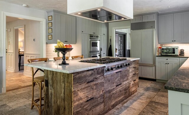 8 Lost Pond Ln, North Salem, NY 10560 - kitchen featuring stainless steel appliances, stone tile flooring, extractor fan, a kitchen island, and a kitchen breakfast bar