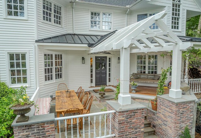 8 Lost Pond Ln, North Salem, NY 10560 - entrance to property featuring a standing seam roof, a shingled roof, a metal roof, outdoor dining area, and a patio area