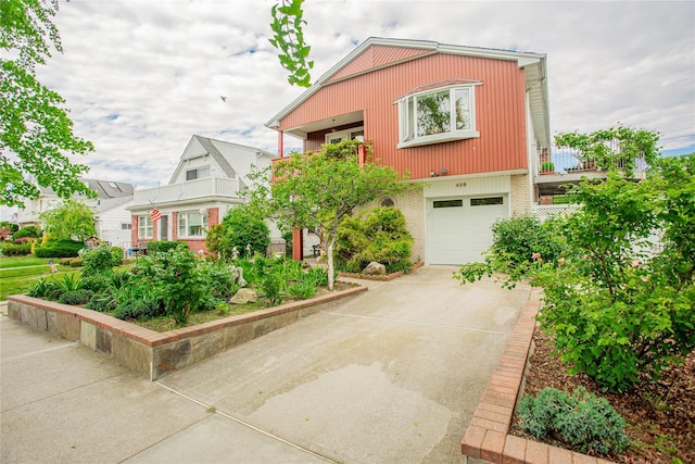429 E Park Ave, Long Beach, NY 11561 - view of front of property with concrete driveway, brick siding, a garage, and a balcony