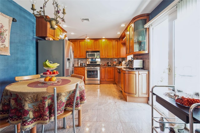 429 E Park Ave, Long Beach, NY 11561 - kitchen featuring stainless steel appliances, brown cabinetry, glass insert cabinets, decorative backsplash, and recessed lighting
