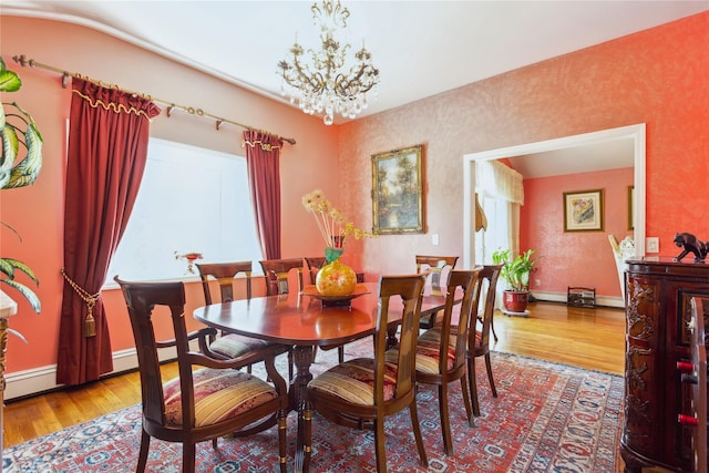 429 E Park Ave, Long Beach, NY 11561 - dining area featuring light wood-style floors, a chandelier, baseboards, and baseboard heating
