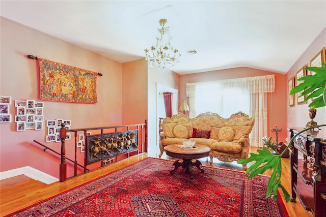 429 E Park Ave, Long Beach, NY 11561 - living room with wood finished floors, a chandelier, vaulted ceiling, and baseboards