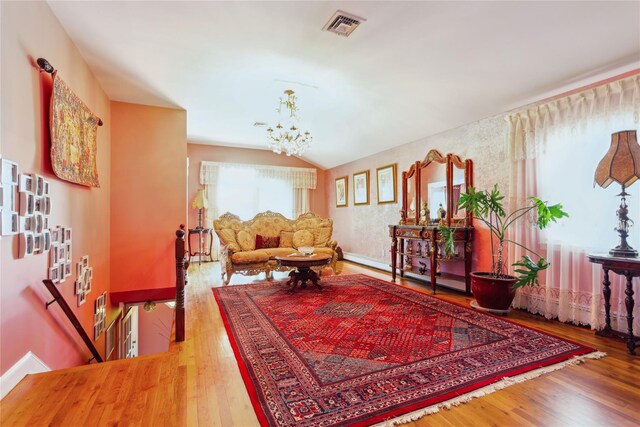 429 E Park Ave, Long Beach, NY 11561 - living area featuring an upstairs landing, wood finished floors, a chandelier, vaulted ceiling, and baseboards