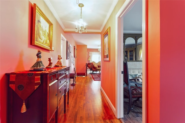 429 E Park Ave, Long Beach, NY 11561 - hall featuring a chandelier, crown molding, wood finished floors, and baseboards