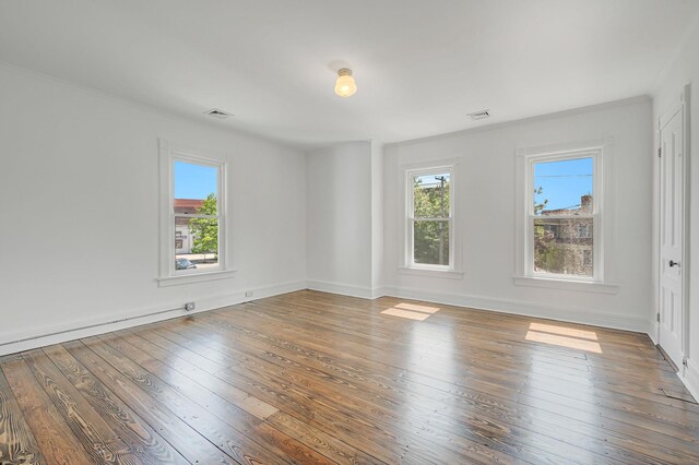 434 Griffing Ave, Riverhead, NY 11901 - empty room featuring plenty of natural light, ornamental molding, wood-type flooring, and baseboards