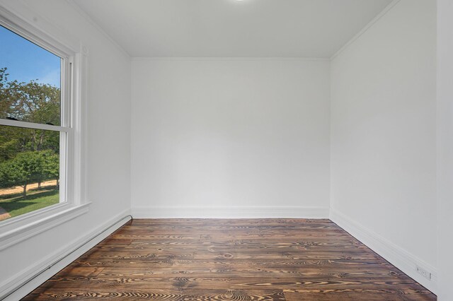 434 Griffing Ave, Riverhead, NY 11901 - spare room with a baseboard heating unit, wood finished floors, crown molding, and baseboards