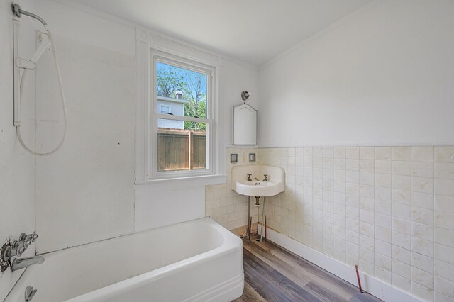 434 Griffing Ave, Riverhead, NY 11901 - bathroom with wood finished floors, tile walls, crown molding, and shower / washtub combination