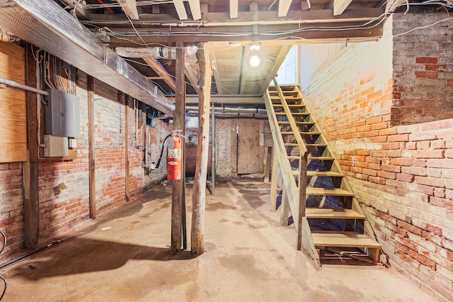 434 Griffing Ave, Riverhead, NY 11901 - unfinished basement with brick wall and stairway