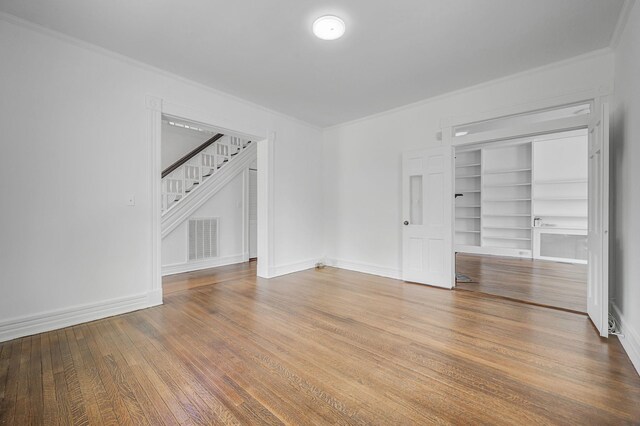 434 Griffing Ave, Riverhead, NY 11901 - empty room with crown molding, stairway, wood finished floors, baseboards, and built in features