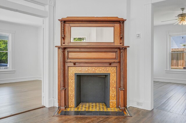 434 Griffing Ave, Riverhead, NY 11901 - detailed view of wood finished floors, baseboards, ceiling fan, and a tiled fireplace