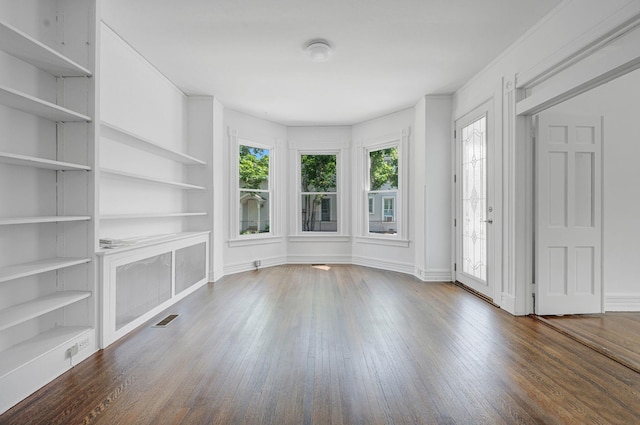 434 Griffing Ave, Riverhead, NY 11901 - unfurnished living room with wood finished floors, built in features, and baseboards