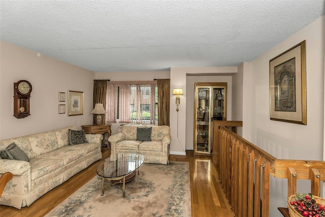 71-14 Sutton Pl Unit 1, Fresh Meadows, NY 11365 - living room featuring wood finished floors and a textured ceiling