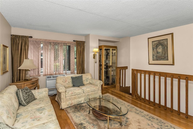 71-14 Sutton Pl Unit 1, Fresh Meadows, NY 11365 - living room with wood finished floors, a textured ceiling, and a baseboard heating unit