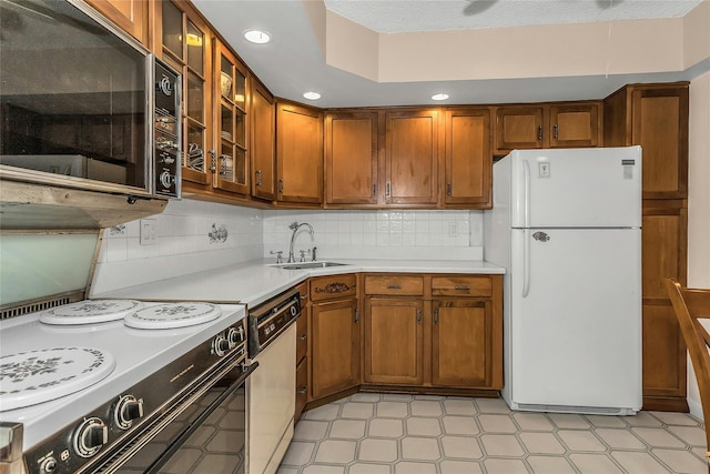 71-14 Sutton Pl Unit 1, Fresh Meadows, NY 11365 - kitchen featuring white appliances, a sink, light countertops, brown cabinets, and recessed lighting