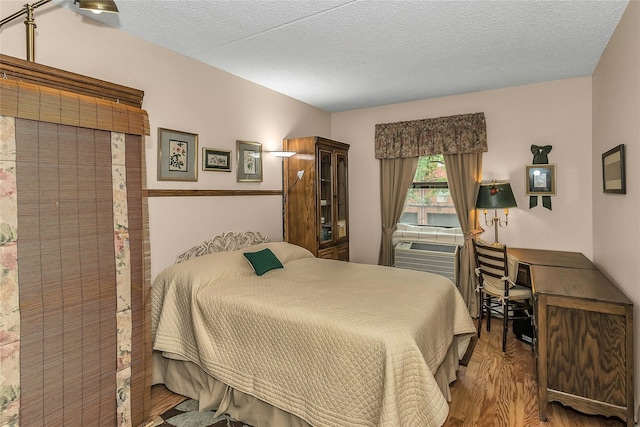 71-14 Sutton Pl Unit 1, Fresh Meadows, NY 11365 - bedroom with wood finished floors, an office area, and a textured ceiling