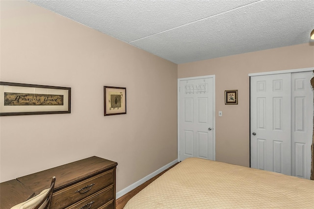 71-14 Sutton Pl Unit 1, Fresh Meadows, NY 11365 - bedroom featuring a closet, baseboards, and a textured ceiling