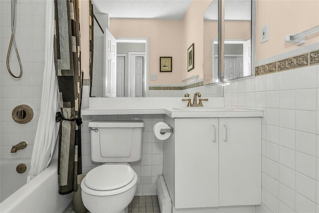 71-14 Sutton Pl Unit 1, Fresh Meadows, NY 11365 - bathroom with tile walls, toilet, shower / bath combination with curtain, vanity, and a baseboard heating unit