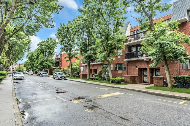 71-14 Sutton Pl Unit 1, Fresh Meadows, NY 11365 - view of asphalt road featuring sidewalks, curbs, and a residential view
