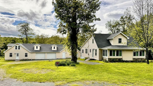 674 Sackett Lake Rd, Monticello, NY 12701 - view of front of house featuring a front yard, a detached garage, and roof with shingles