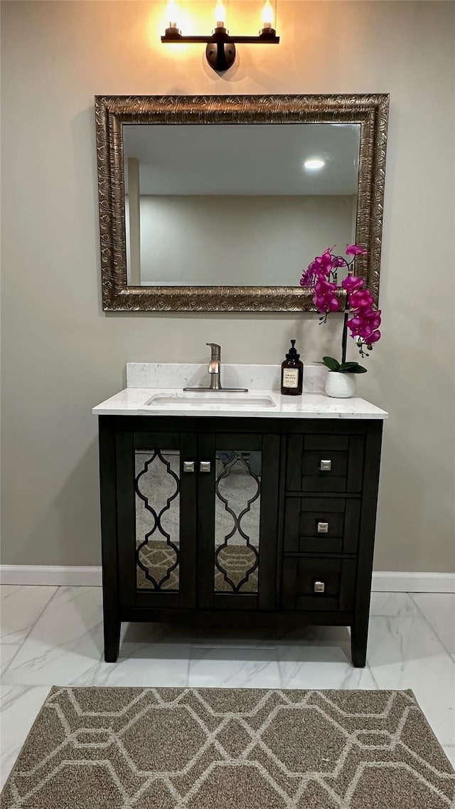 674 Sackett Lake Rd, Monticello, NY 12701 - bathroom with marble finish flooring, baseboards, and vanity
