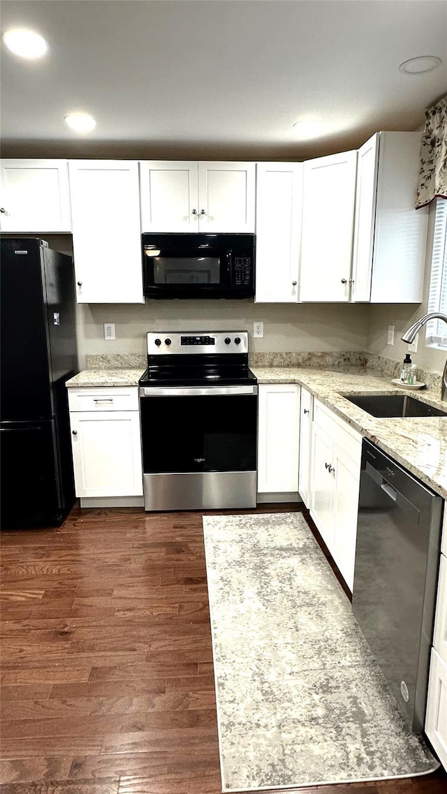 674 Sackett Lake Rd, Monticello, NY 12701 - kitchen featuring black appliances, a sink, white cabinets, dark wood-type flooring, and recessed lighting